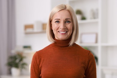 Photo of Portrait of smiling middle aged woman at home