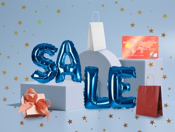 Sale flyer design with word of shiny balloons and gift box on light blue background