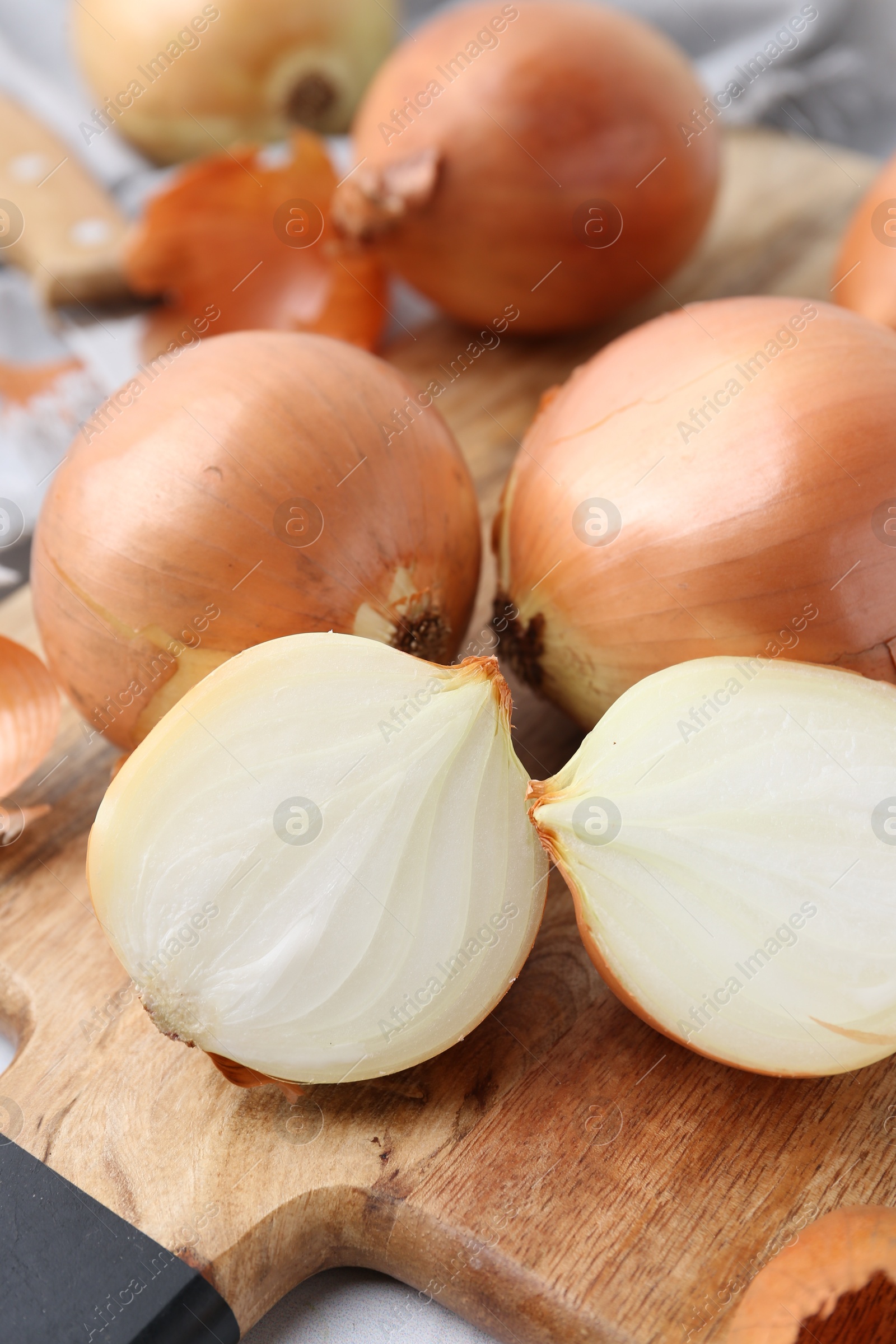 Photo of Fresh onions with peels on table, closeup