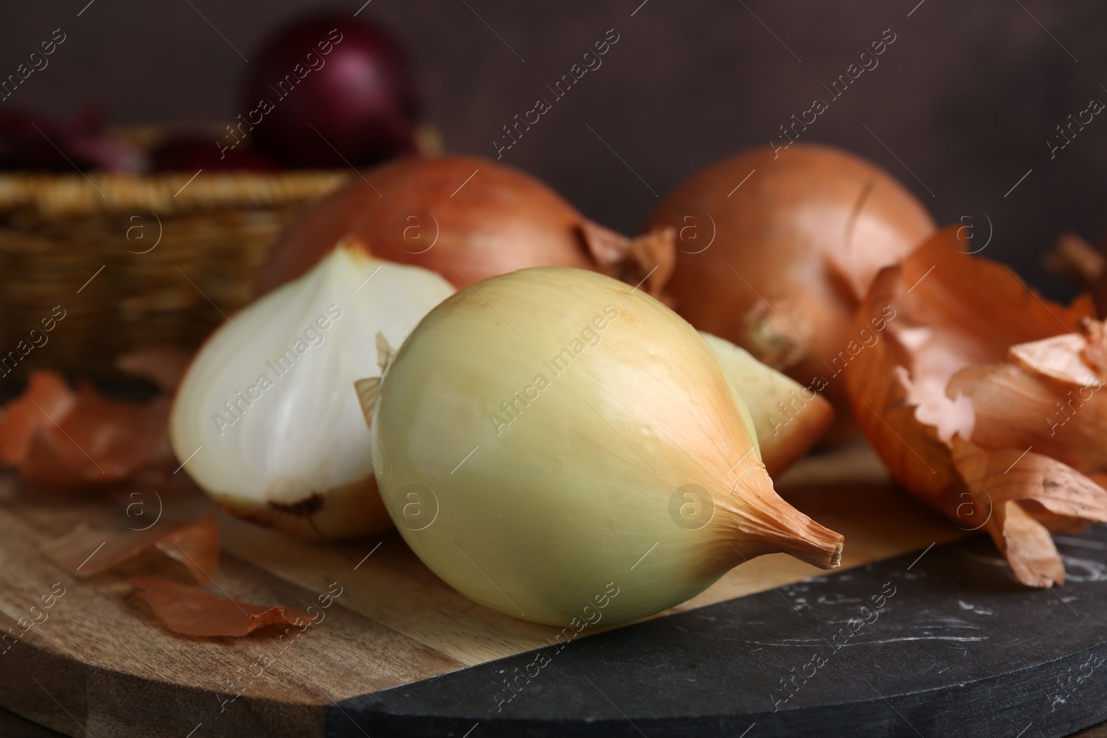 Photo of Fresh onions with peels on table, closeup