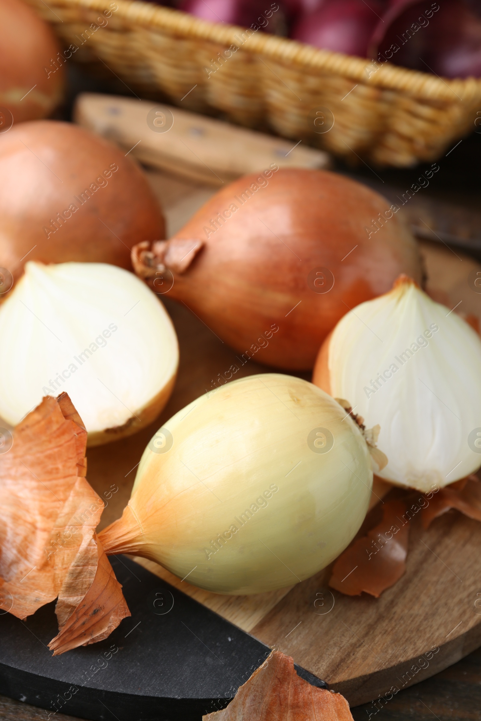 Photo of Fresh onions with peels on table, closeup