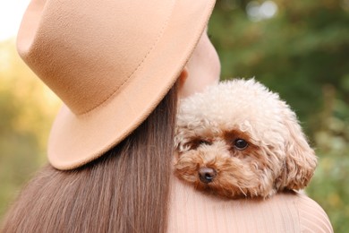 Woman with her cute dog outdoors, closeup