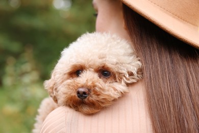 Woman with her cute dog outdoors, closeup