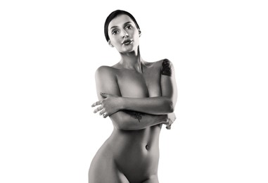 Beautiful nude woman posing on white background, black and white effect