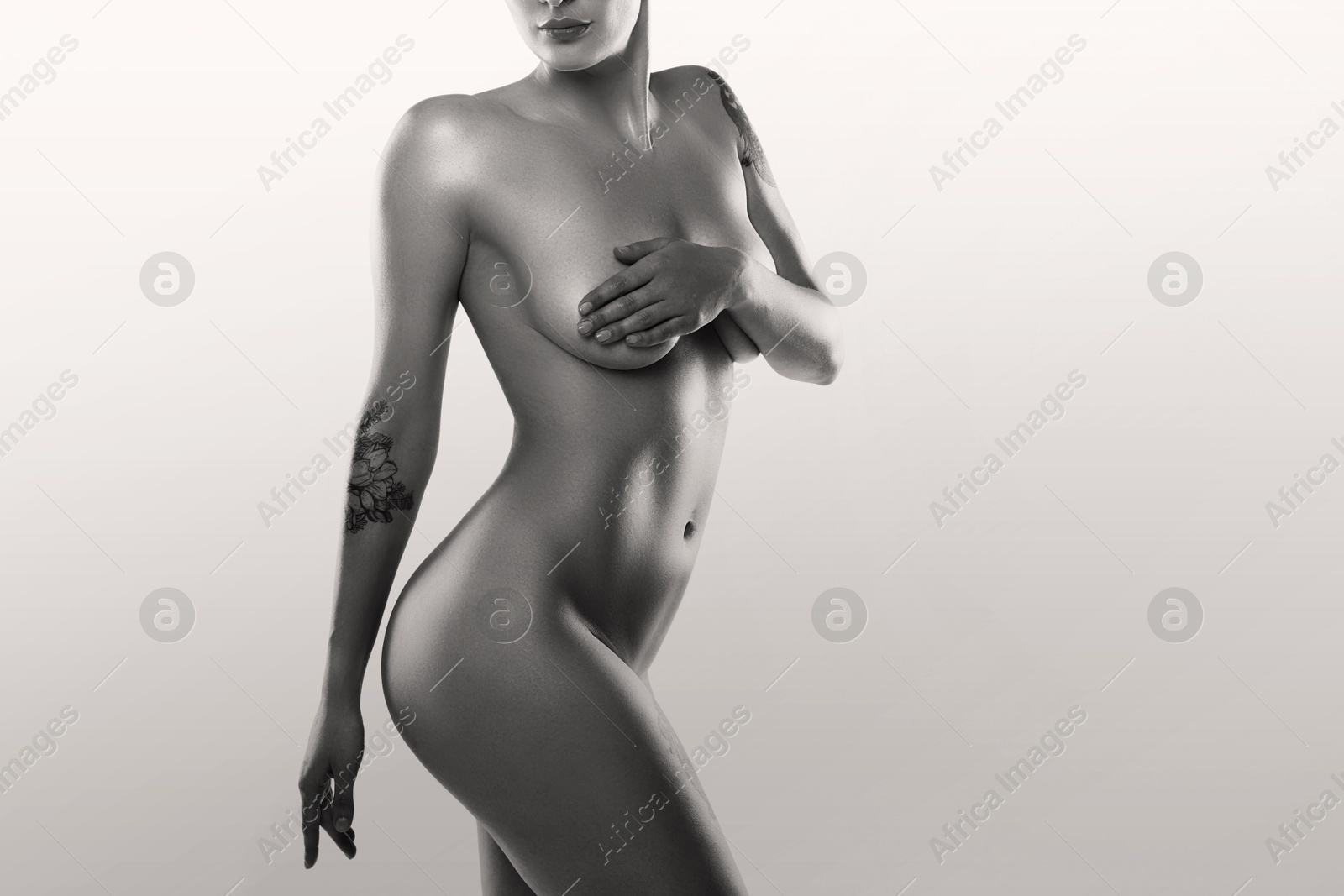 Image of Beautiful nude woman posing on white background, closeup. Black and white effect