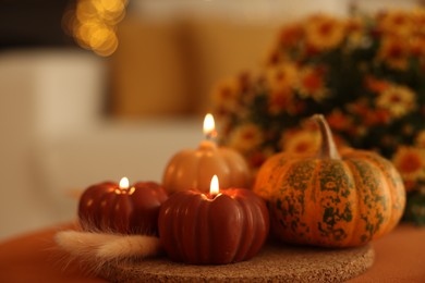 Photo of Burning candles, pumpkin and spikelets indoors, space for text. Autumn atmosphere