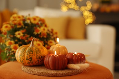 Photo of Burning candles, pumpkin and spikelets indoors, space for text. Autumn atmosphere