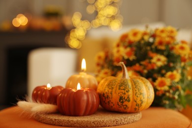 Photo of Burning candles, pumpkin and spikelets indoors, space for text. Autumn atmosphere