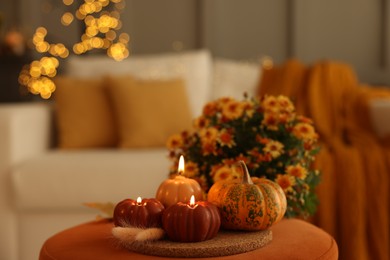 Photo of Burning candles, pumpkin and spikelets indoors, space for text. Autumn atmosphere