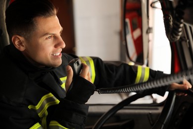 Firefighter using radio set while driving fire truck