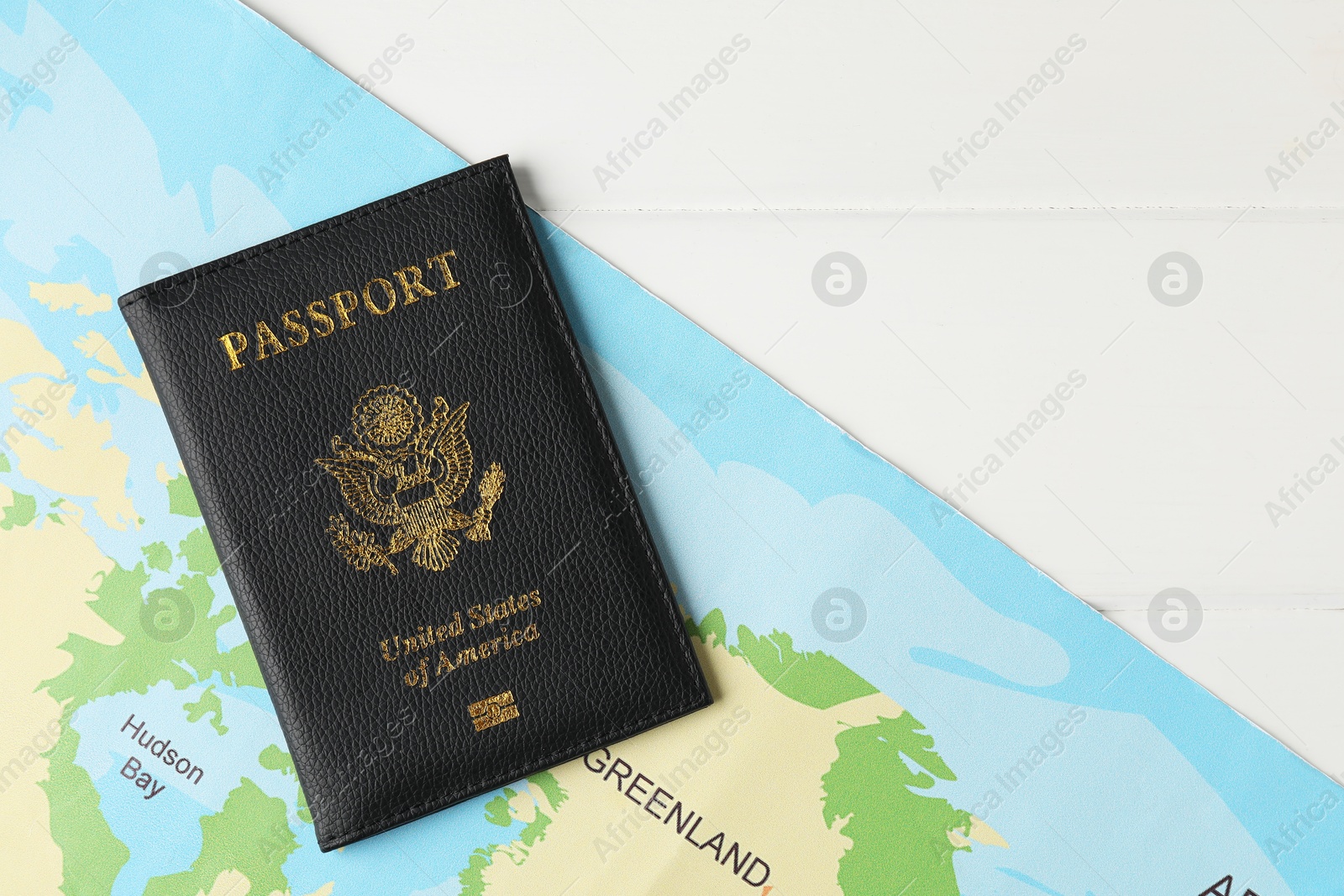 Photo of Passport and world map on white wooden table, flat lay