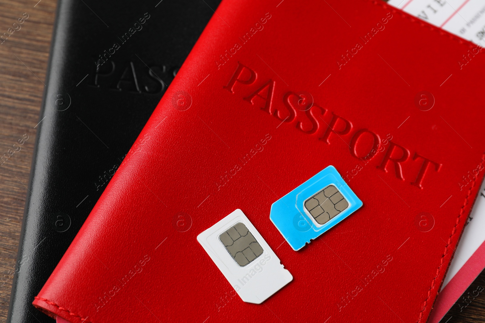 Photo of Passports and SIM cards on wooden table