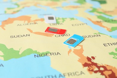 Photo of Group of SIM cards on world map, closeup