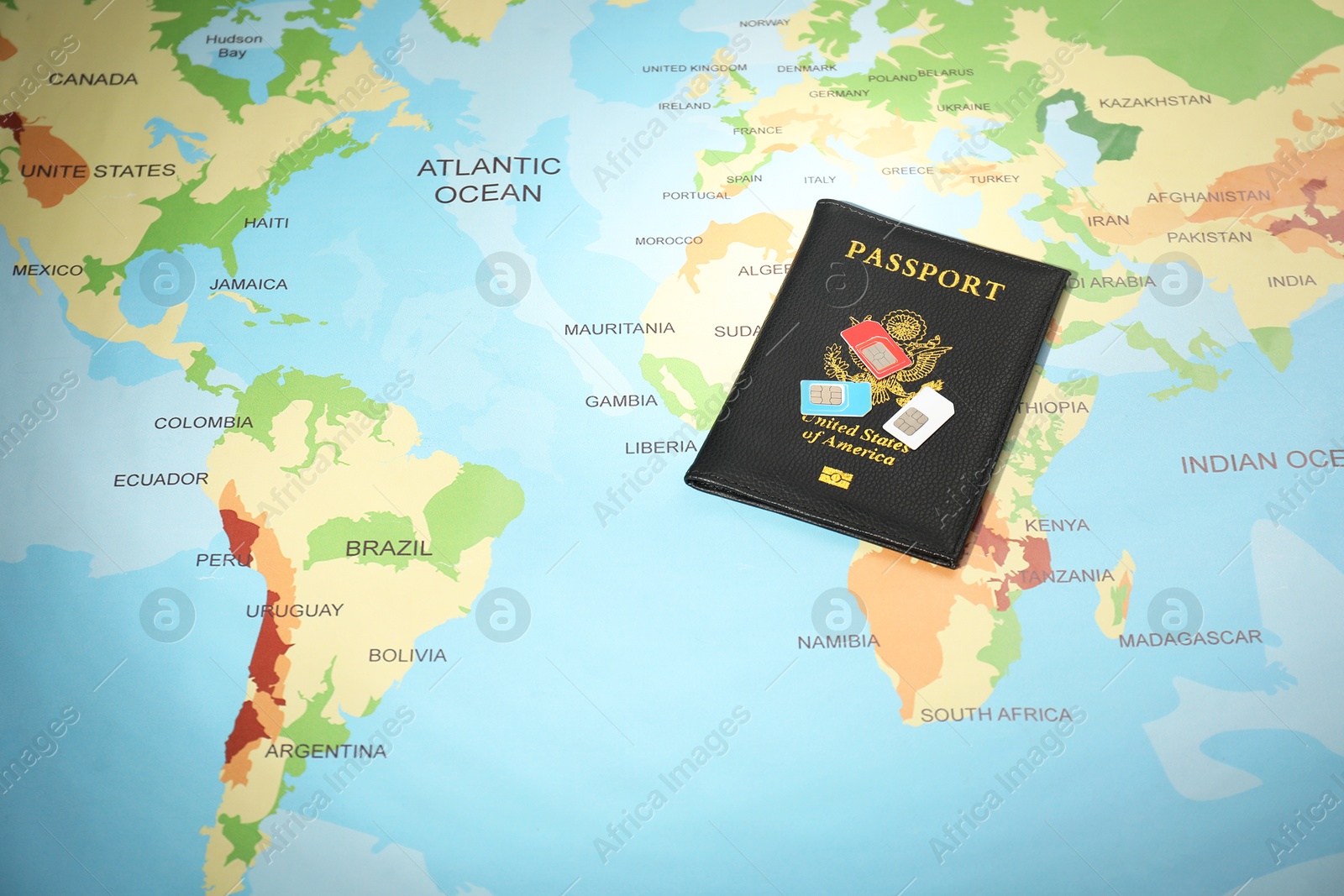 Photo of Modern SIM cards and passport on world map