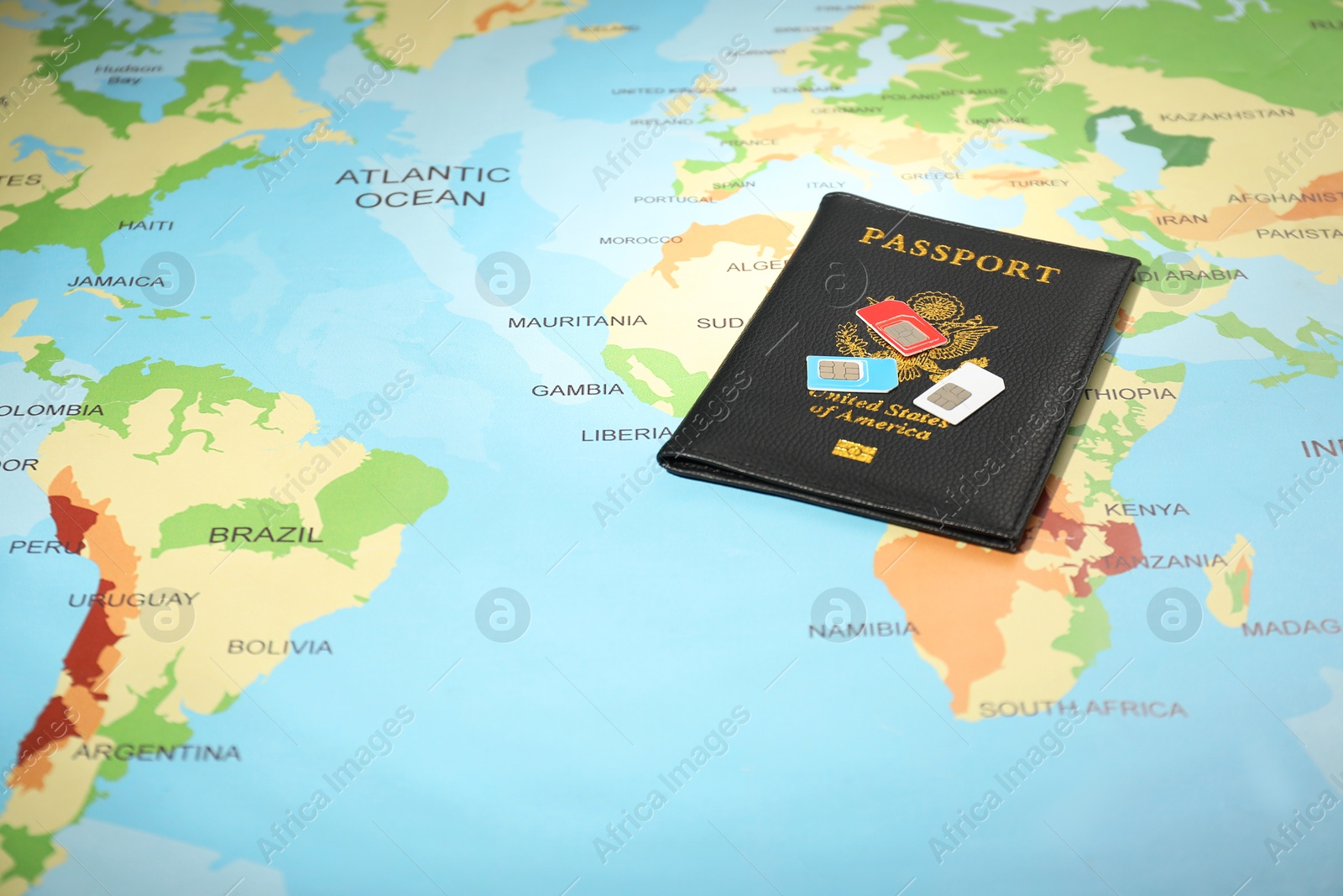 Photo of Modern SIM cards and passport on world map