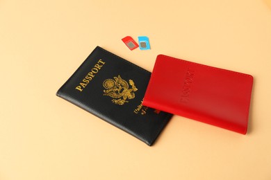 Photo of Modern SIM cards and passport on beige background