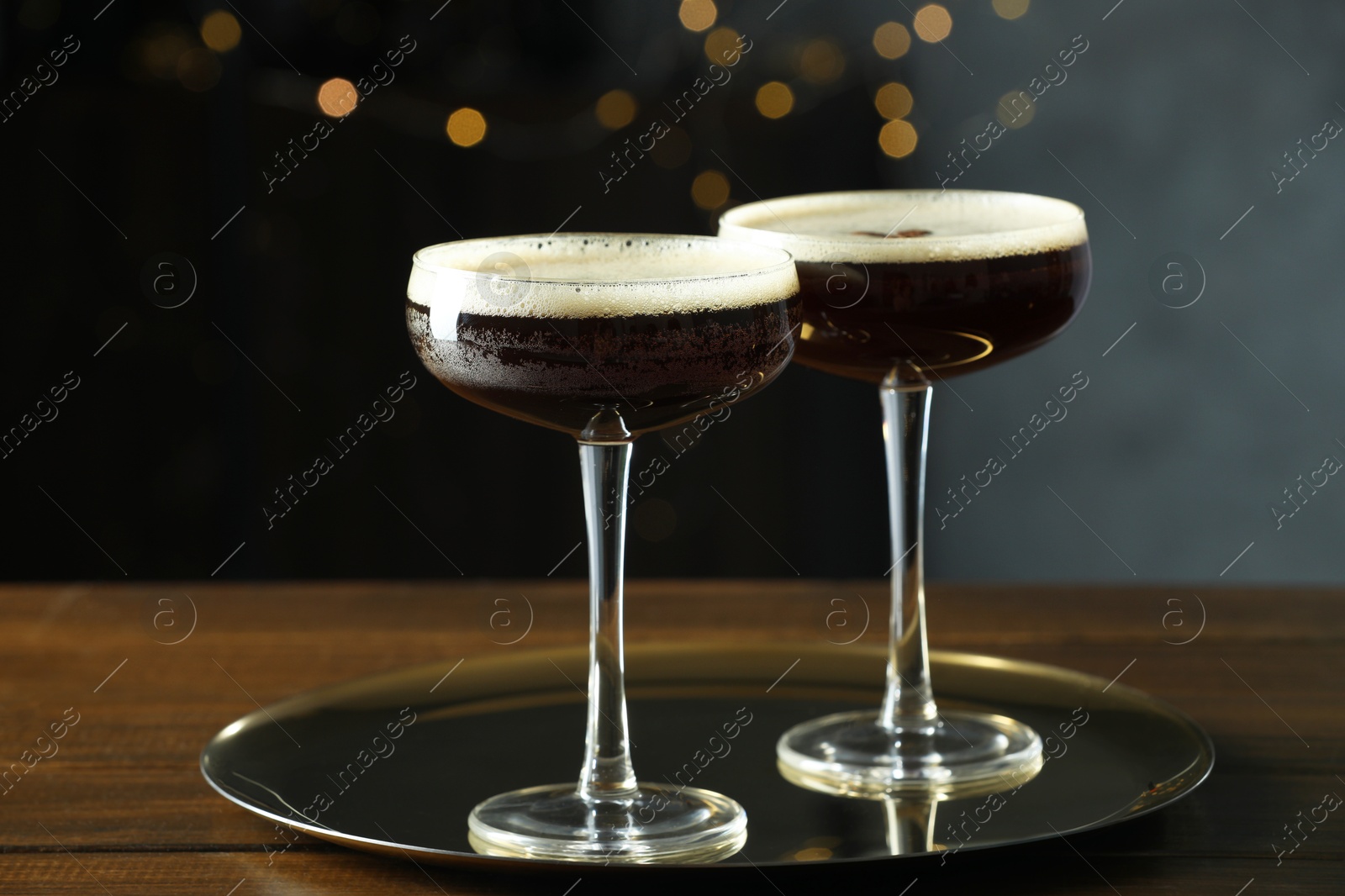 Photo of Refreshing cocktails in glasses on wooden table