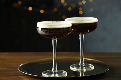 Refreshing cocktails in glasses on wooden table