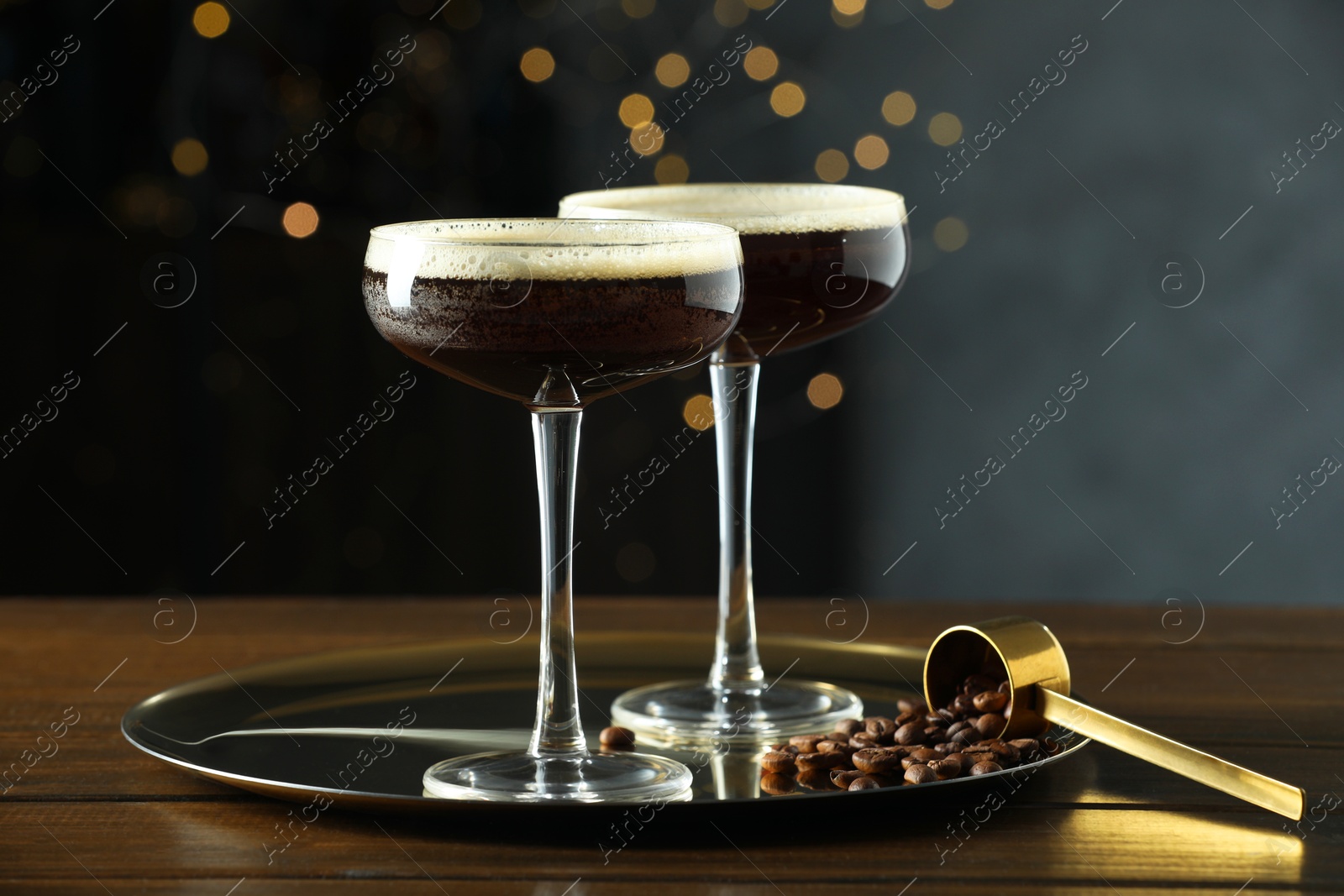 Photo of Refreshing cocktails and coffee beans on wooden table