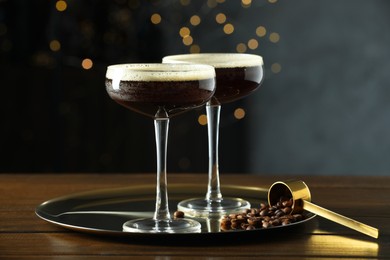 Refreshing cocktails and coffee beans on wooden table