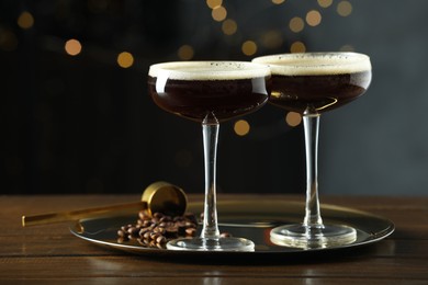 Refreshing cocktails and coffee beans on wooden table