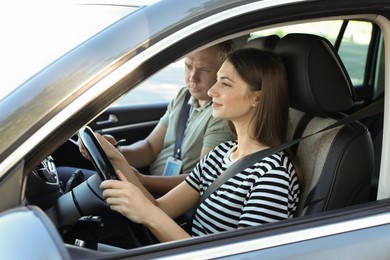 Driving school. Student passing driving test with examiner in car