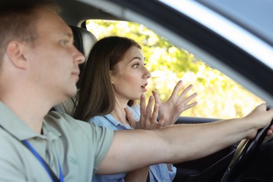 Photo of Driving school. Emotional woman having driving lesson