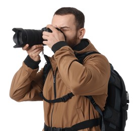 Photographer with backpack and camera taking picture on white background