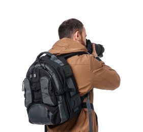 Photographer with backpack and camera taking picture on white background, back view