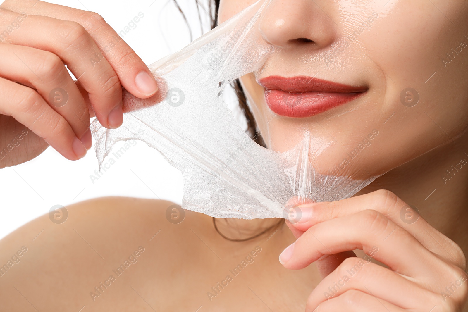 Photo of Woman peeling off face mask on white background, closeup