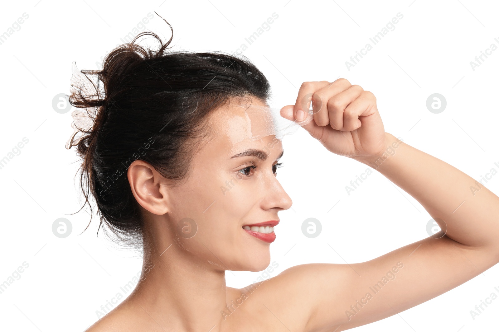 Photo of Smiling woman peeling off face mask on white background