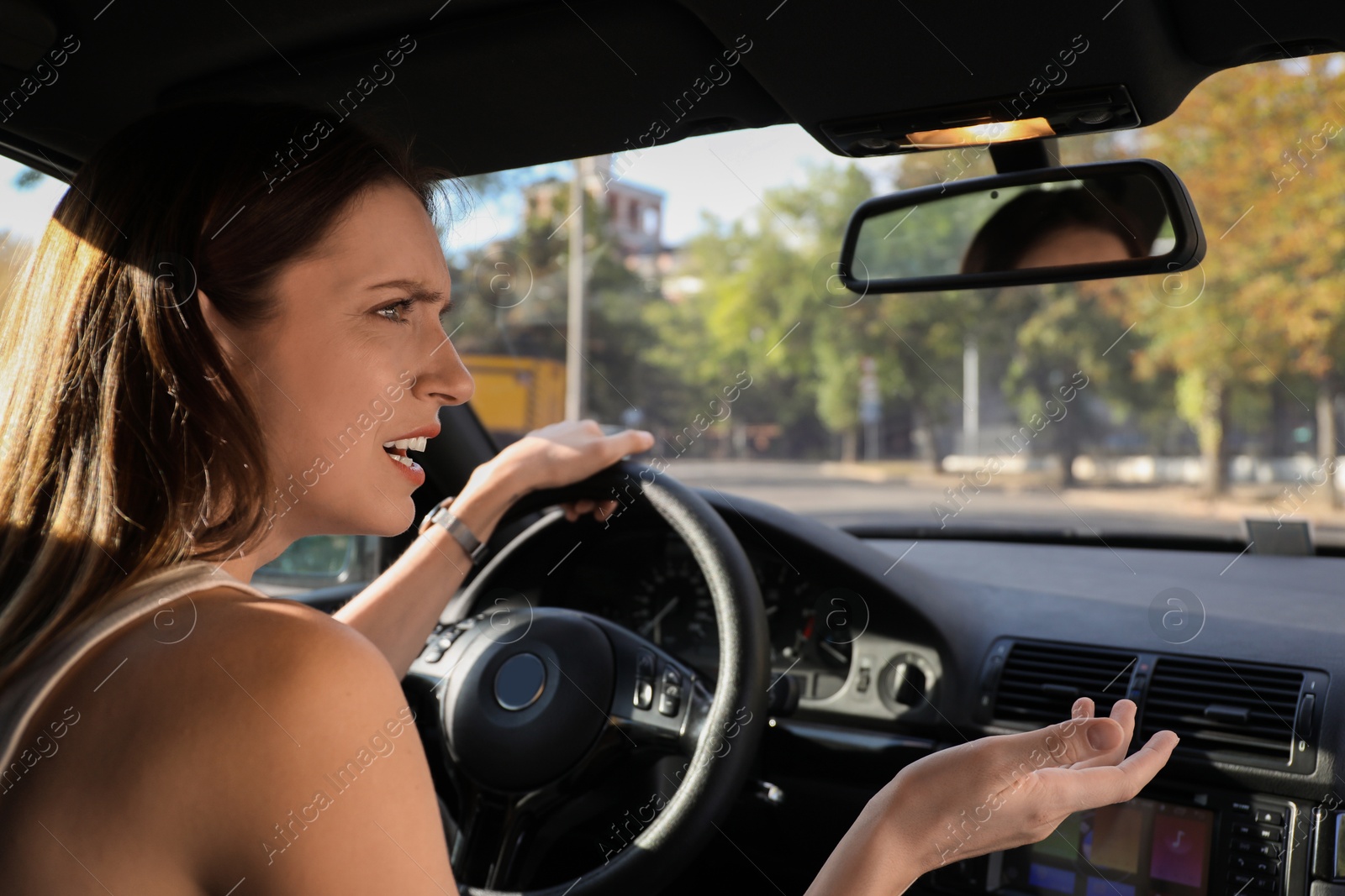 Photo of Emotional woman behind steering wheel driving car