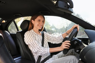 Woman holding steering wheel while driving car