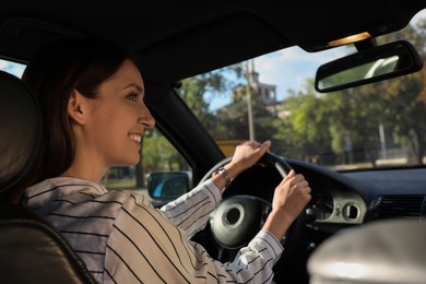 Photo of Woman holding steering wheel while driving car