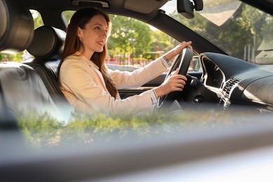 Photo of Woman holding steering wheel while driving car