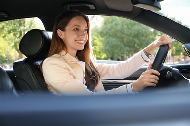 Woman holding steering wheel while driving car