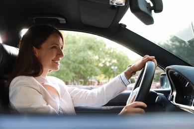 Woman holding steering wheel while driving car