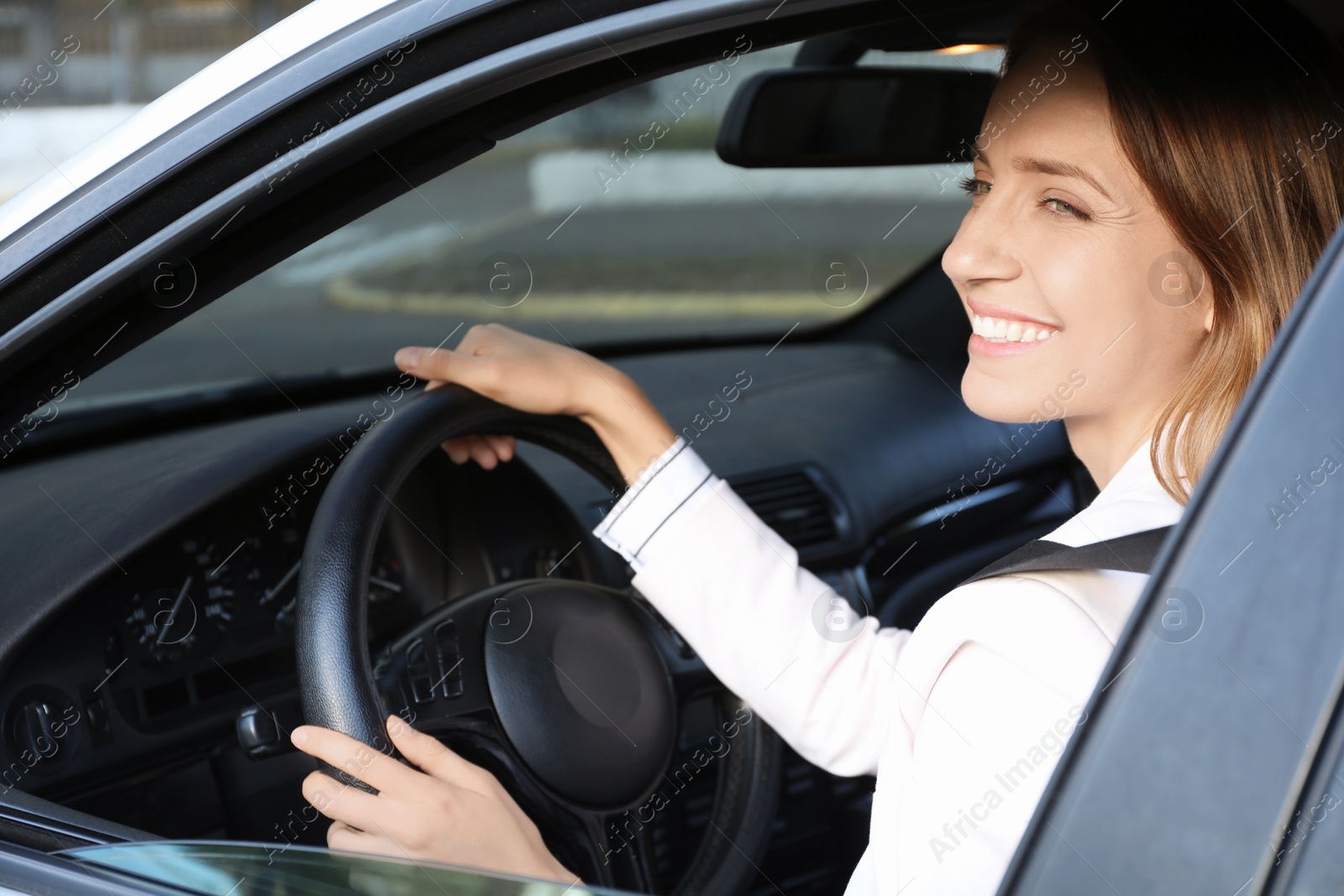 Photo of Woman holding steering wheel while driving car