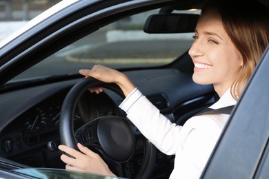 Woman holding steering wheel while driving car