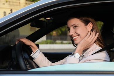 Photo of Woman holding steering wheel while driving car