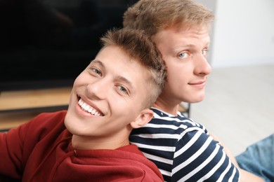 Photo of Family portrait of happy brothers at home