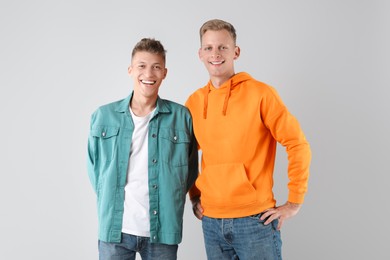 Photo of Portrait of two happy brothers on light background