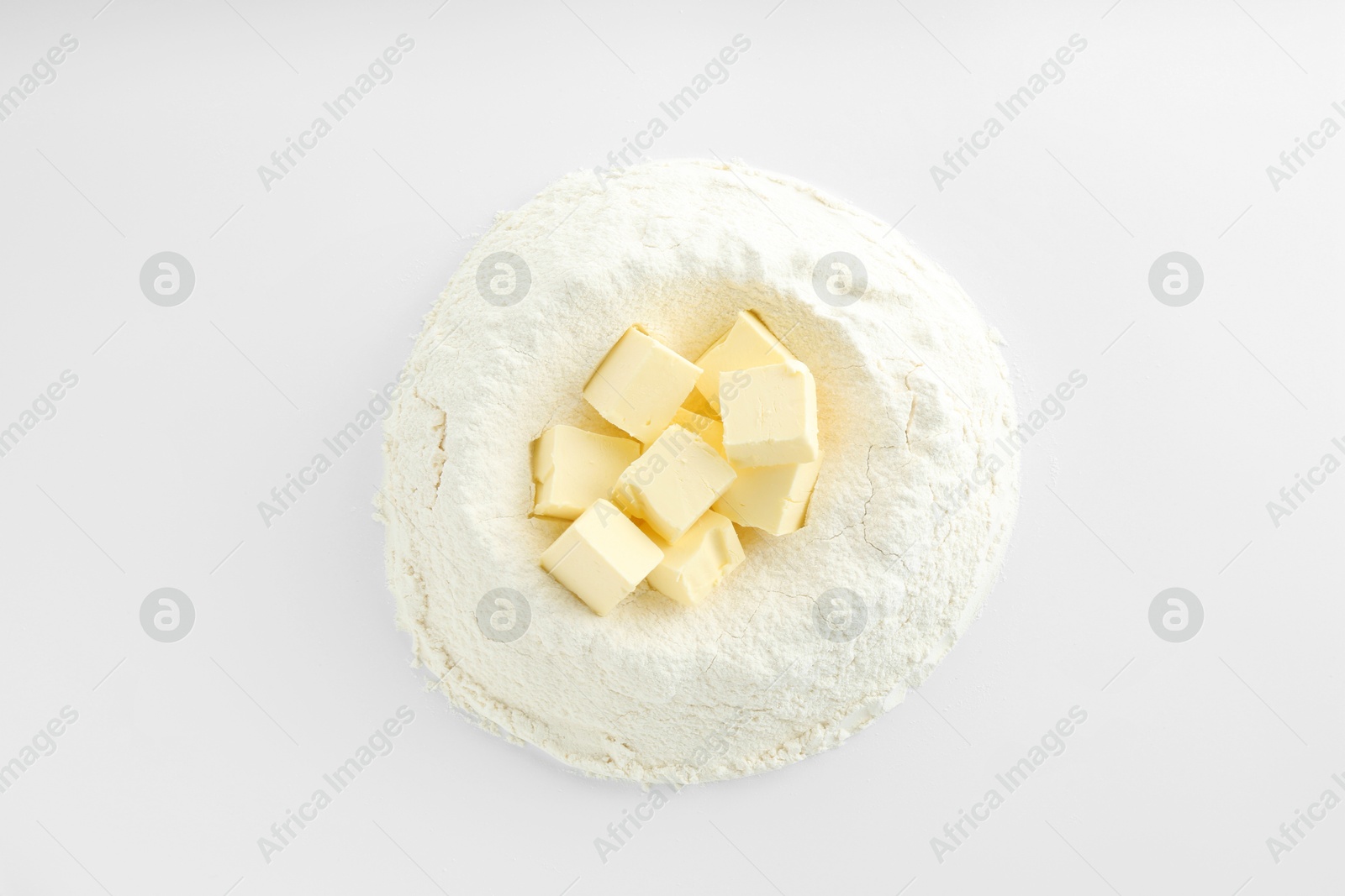 Photo of Cooking homemade pie. Flour with butter on white background, top view