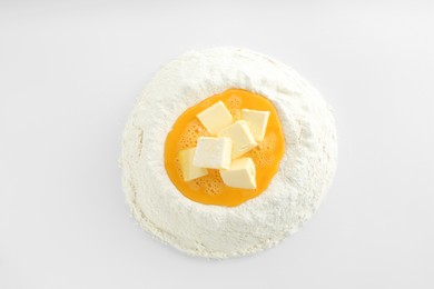 Photo of Cooking homemade pie. Flour with eggs and butter on white background, top view