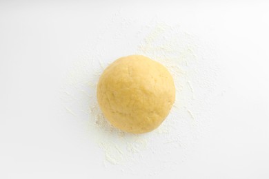 Photo of Cooking homemade pie. Raw dough and flour on white background, top view