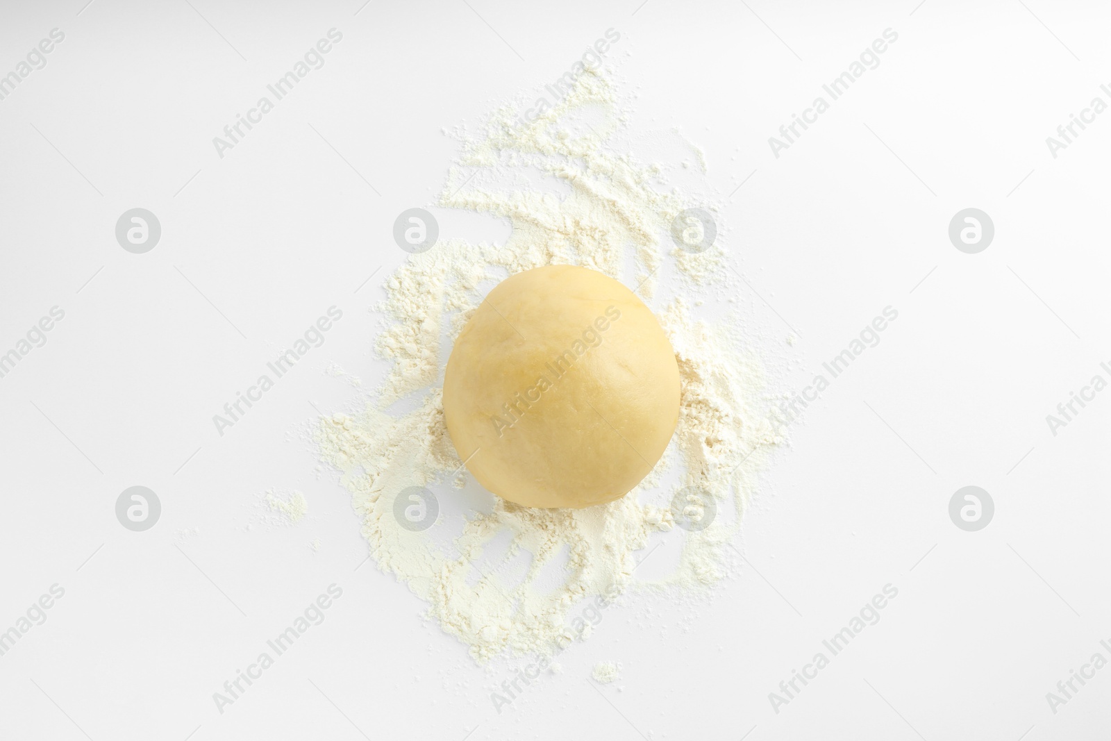 Photo of Cooking homemade pie. Raw dough and flour on white background, top view