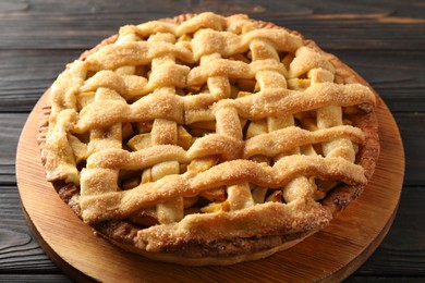 Tasty homemade apple pie on wooden table, closeup