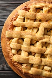 Tasty homemade apple pie on wooden table, top view