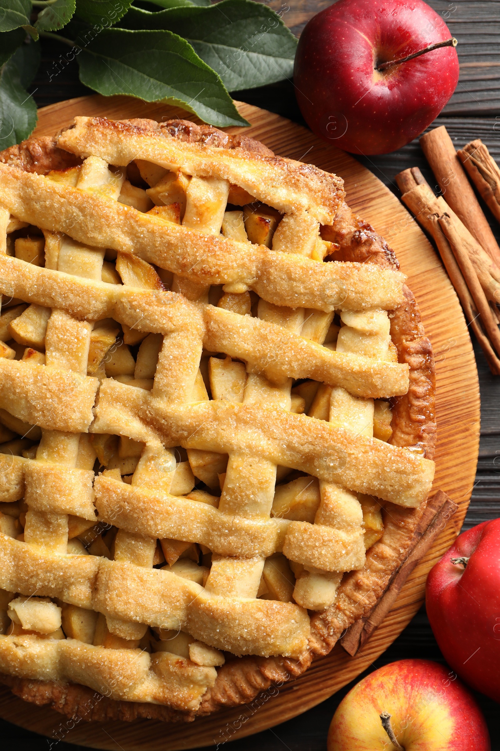 Photo of Tasty homemade apple pie and ingredients on table, flat lay