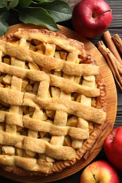 Tasty homemade apple pie and ingredients on table, flat lay